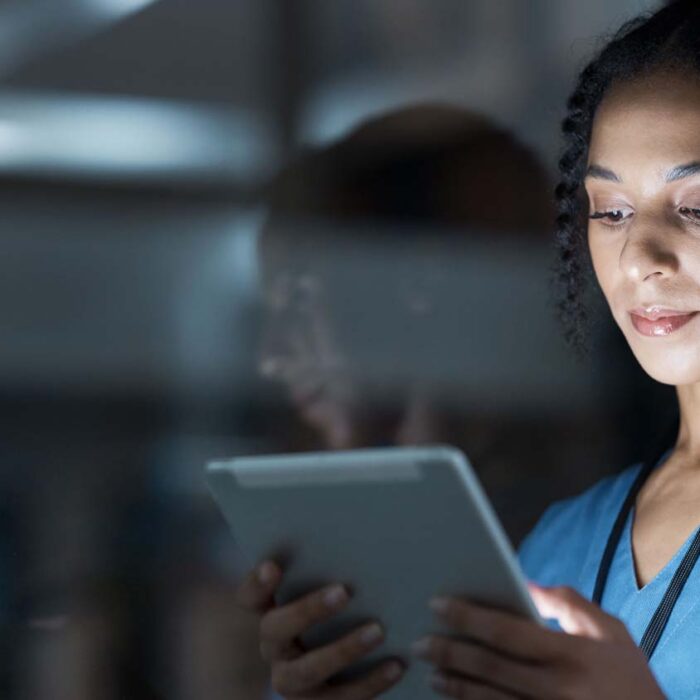 Nurse looking at data on tablet